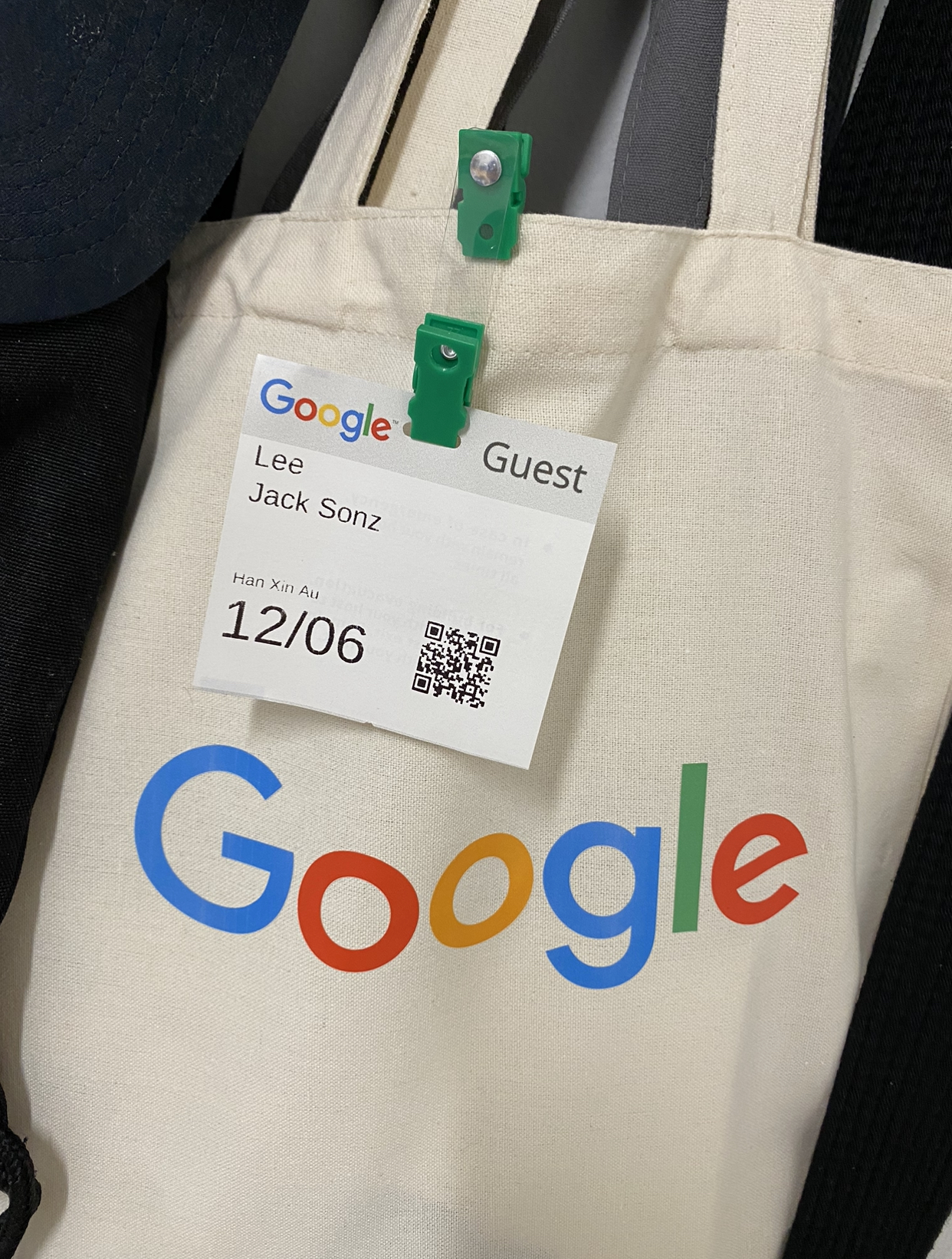 Event guest name tag clipped onto Google branded tote bag